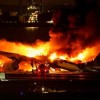 羽田空港で日本航空機が炎上、海保機と衝突　乗客乗員379人全員脱出と