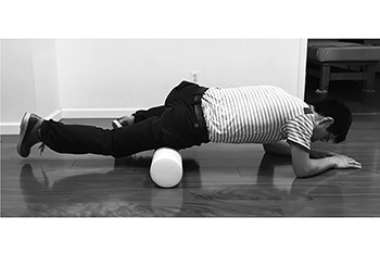 腕で身体のバランスをとりながら太ももの前をマッサージする。