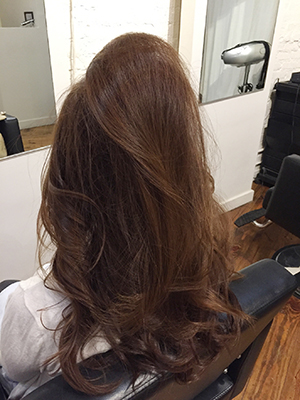 トップの巻いた部分に スプレーワックスをかける。 残った髪をコテで縦に巻く。